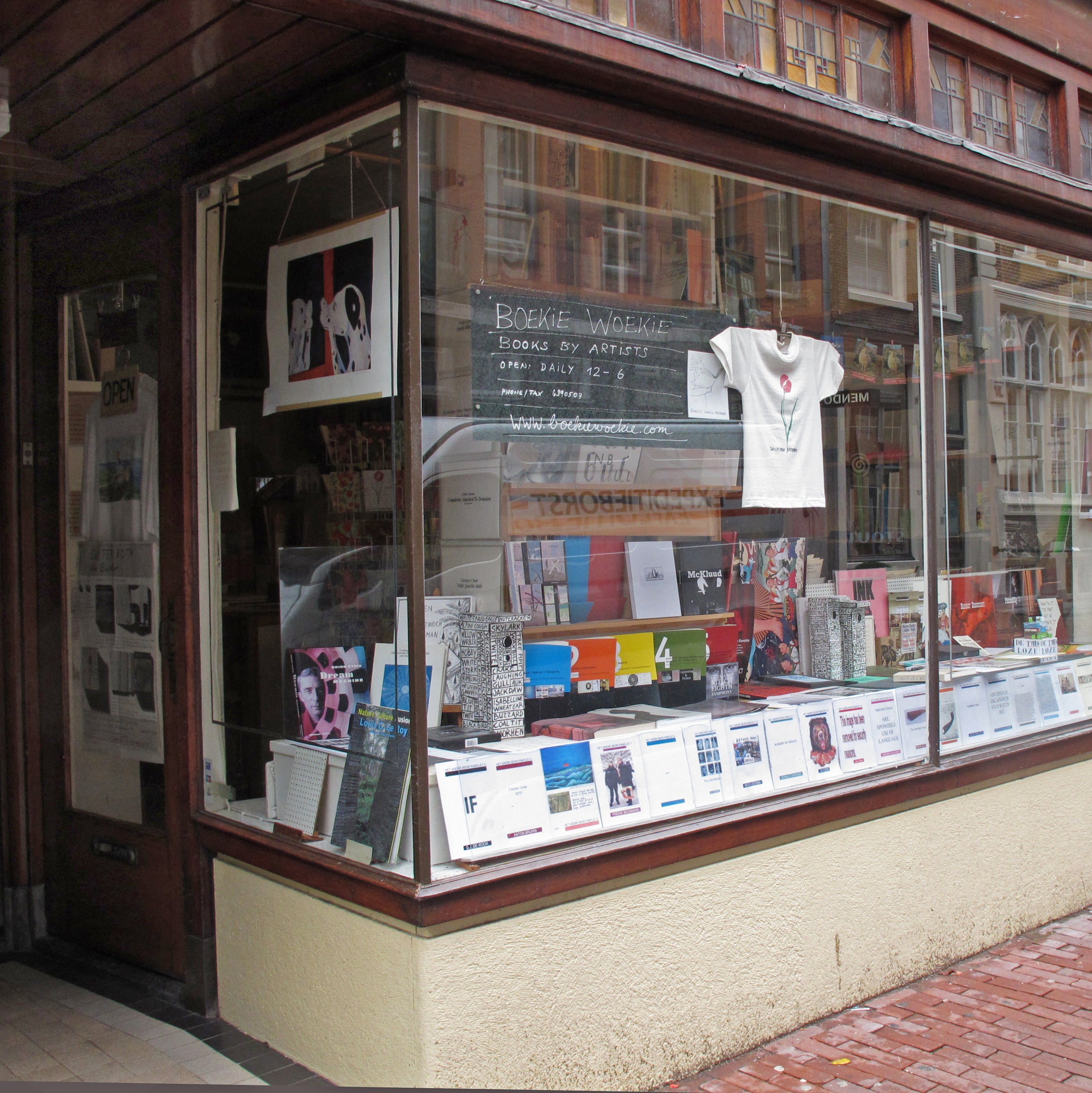 Storefront window display with books and a t-shirt on a hanger